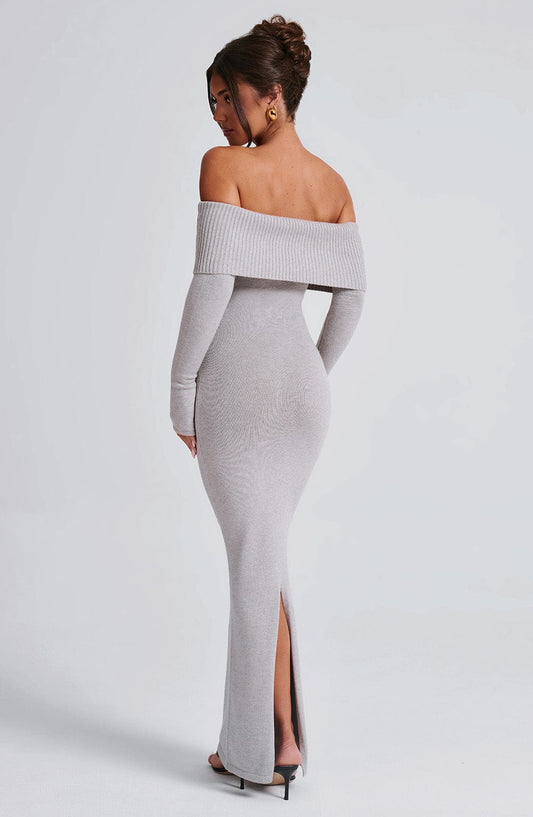 Vestido largo gris claro off-shoulder con abertura frontal y manga larga caídas.