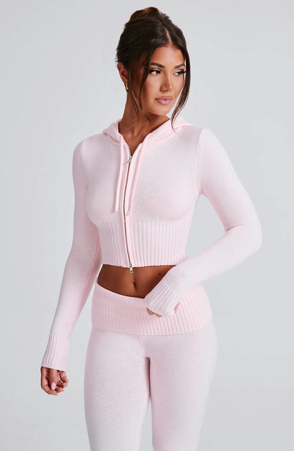 Sudadera rosa con capucha ajustable, cremallera frontal y punto acanalado en el torso