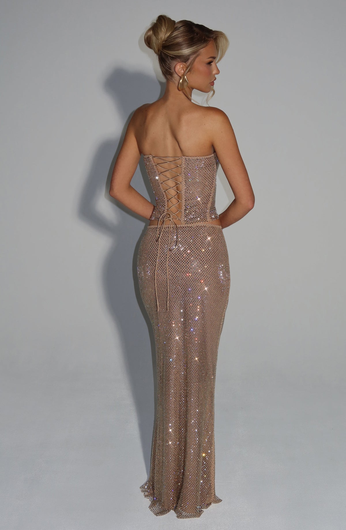Conjunto con espalda cruzada y falda larga de lentejuelas doradas